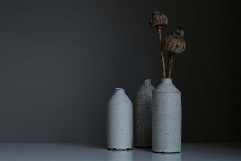 Three handmade ceramic vases on a table, with no people in the frame